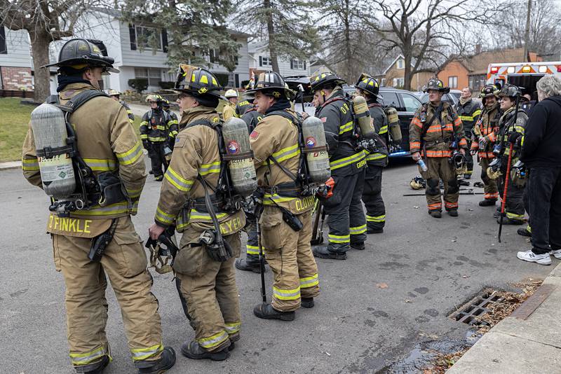 Firefighters work at the scene of a fire located at 712 Madison Ave. in Dixon. A backyard pigpen started on fire and spread to the house.