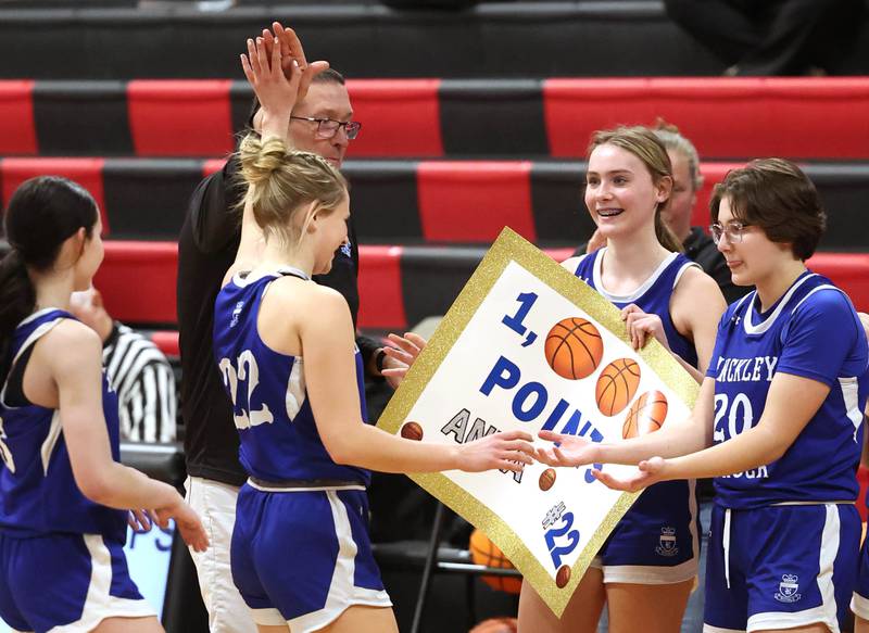 Hinckley-Big Rock's Anna Hermann is congratulated by her coach and teammates after scoring her 1,000th career point on a free throw during their game Monday, Jan. 13, 2025, at Indian Creek High School in Shabbona.