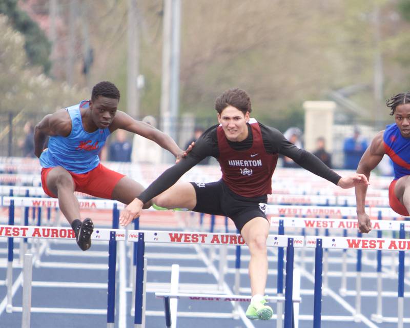 West Aurora's Azuriah Sylvester and Wheaton Academy's Canyon Roberts compete in the 110 Meter Hurdles at the Peterson Prep Invitational by Kaneland on Saturday, April 20,2024 at West Aurora High School in Aurora.