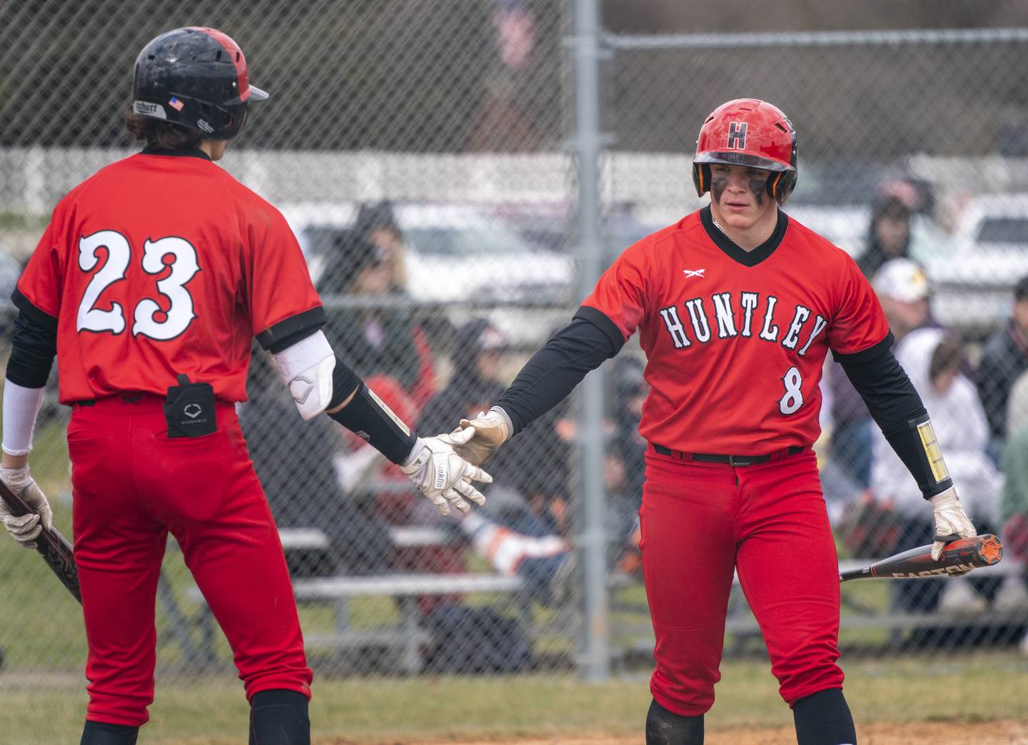 Huntley's Chase Jetel (23) congratulates teammate Brayden Bakes after he scored a run in the sixth inning during their game against McHenry on Saturday, April 9, 2022 at Petersen Park in McHenry. Huntley won 7-5. Ryan Rayburn for Shaw Local