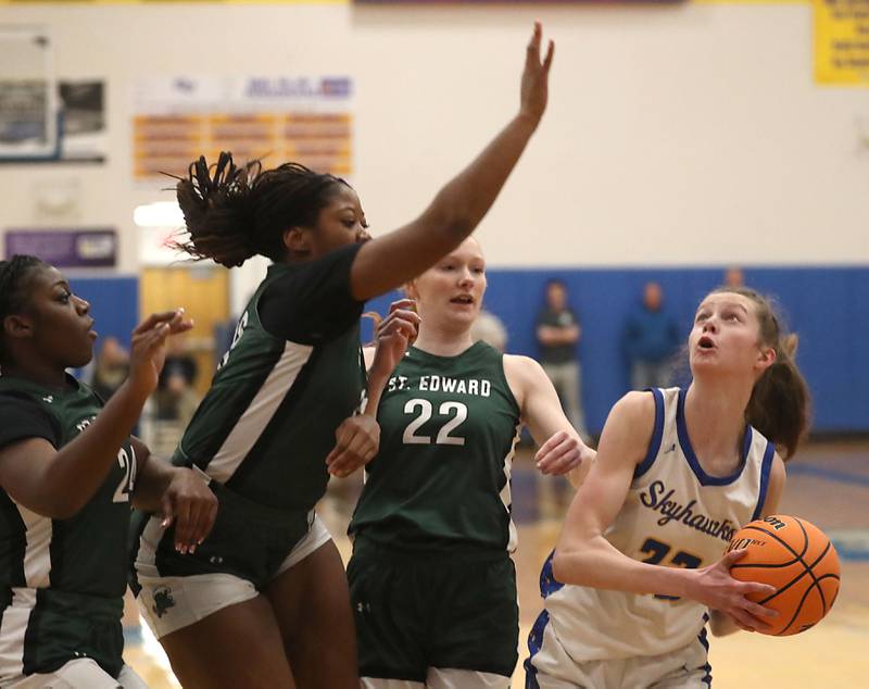 Johnsburg's Skye Toussaint (right) looks to shoot as she is guarded by St. Edward's Jordin Sauls (left) and Layne Dawson (center) during the IHSA Class 2A Johnsburg Sectional girls basketball championship game on Thursday, February, 26, 2026, at Johnsburg High School.