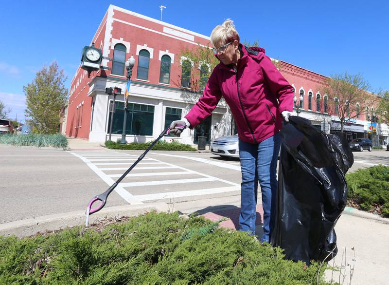 Christa Cross, of Ottawa, cleans up trash during Operation Clean Sweep on Saturday, April 26, 2025 downtown Ottawa. In honor of Earth Day this week, the Ottawa Downtown Association asked community members to participate in the cleanup. Volunteers helped clean litter throughout downtown Ottawa beginning in the Jordan block.