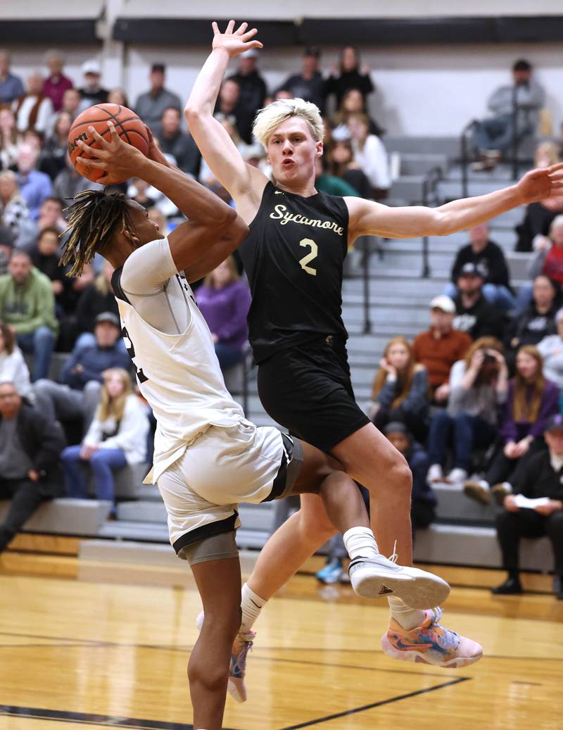 Sycamore's Aidan Wyzard goes for the block against Kaneland's Isaiah Gipson during their game Friday, Jan. 5, 2024, at Kaneland High School in Maple Park.