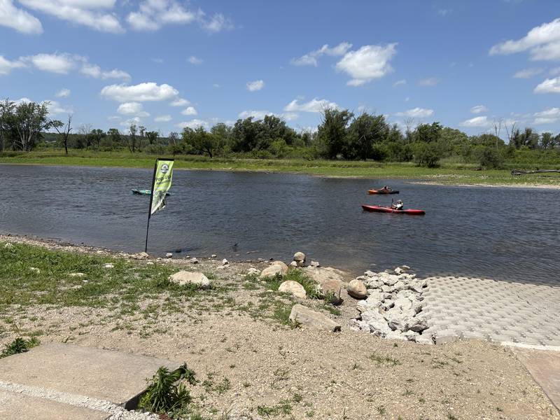 Paddlers paddle along the Fox River during the "El Cardunal" paddle June 22, 2025.