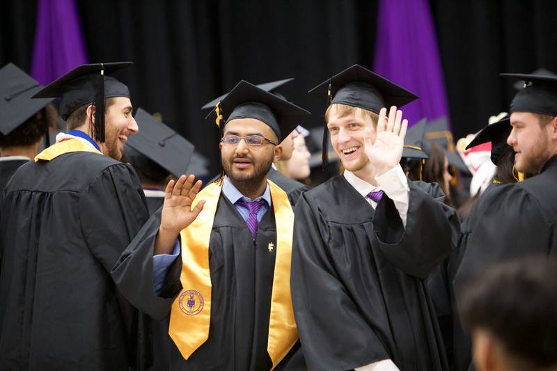 Graduates wave to family and friends before commencement at McHenry County College on Saturday, May 11, 2024, in Crystal Lake.
