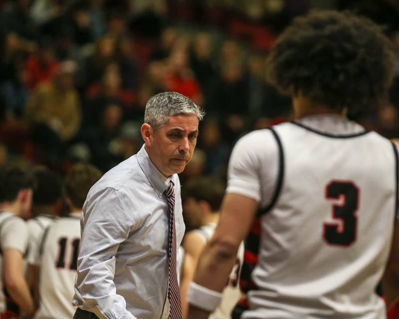 Benet's head coach Gene Heidkamp meets Benet's Jayden Wright (3) as he comes off the court during their Class 4A Bolingbrook Sectional semifinal basketball game between Yorkville at Benet, March 3, 2026 in Bolingbrook.