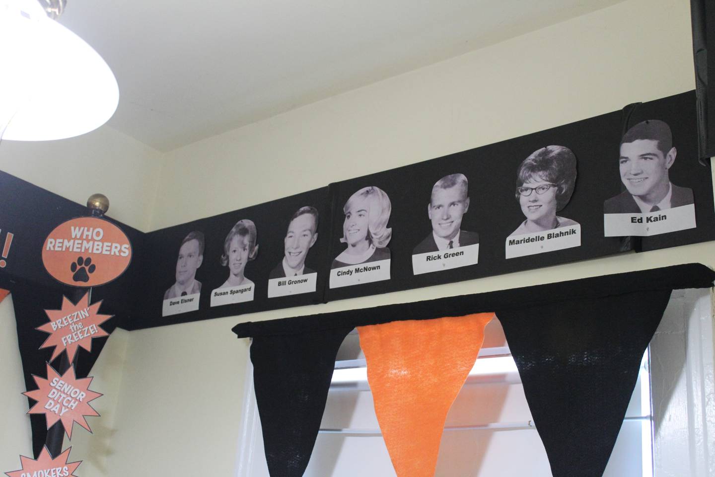 Yearbook photos of 1965 Crystal Lake Central High School classmates border the wall at the Colonel Palmer House in Crystal Lake.