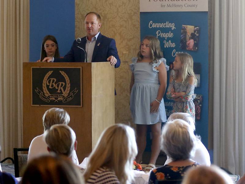 Kirk Hoeppel and his children, Mackenzie, Kayla and Ellie, accept the first Woman of Inspiration award for their wife and mother, Lisa Hoeppel, during the Northwest Herald's Women of Distinction award luncheon Wednesday June 29, 2022, at Boulder Ridge Country Club, 350 Boulder Drive in Lake in the Hills. The luncheon recognized 10 women in the community as Women of Distinction plus the first recipient of the Kelly Buchanan Woman of Inspiration award. Hoeppel was a volunteer cheer coach, a volunteer with school and other local organizations, and a substitute teacher. She succumbed to her third battle with breast cancer April 10 at the age of 40.
