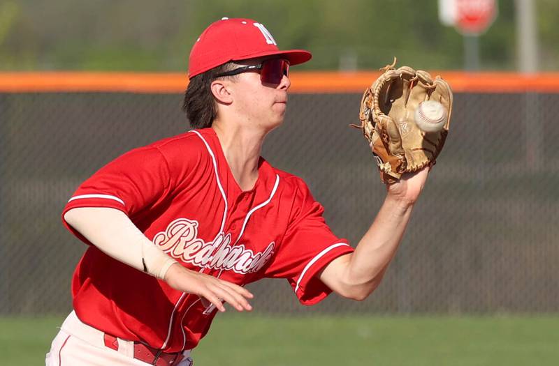 Naperville Central's Cooper Page catches a line drive in the infield during their game against DeKalb Tuesday, April 30, 2024, at DeKalb High School.