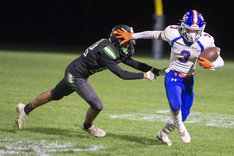 Rock Falls’ Austin Castaneda is stiff armed Genoa-Kingston’s Brody Engel Friday, Sept. 23, 2022.