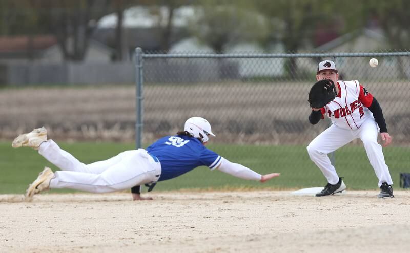Hinckley-Big Rock's Martin Ledbetter dives back safely on a pickoff attempt as Indian Creek's Luke Deutsch takes the throw during their game Monday, May 1, 2023, at Indian Creek High School in Shabbona.