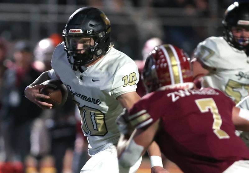 Sycamore's Burke Gautcher pick up yardage after scrambling away from the Morris pass rush during their game Friday, Oct. 20, 2023, at Morris High School.