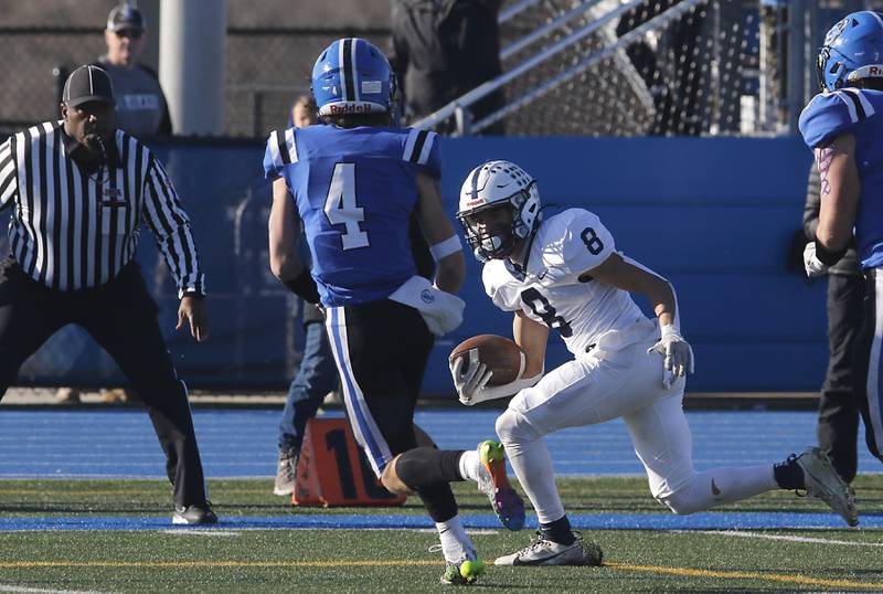 Cary-Grove's Andrew Prio tries to run past Lake Zurich's Nolan Siko after breaking a tackle during a IHSA Class 6A semifinal playoff football game on Saturday, Nov. 18, 2023, at Lake Zurich High School.