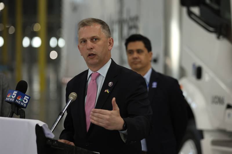 Congressman Sean Casten speaks while Nate Baguio, Senior Vice President of Commercial Development for Lion Electric, looks on during a press conference and interactive tour of the Lion Electric vehicle manufacturing facility. Monday, Mar. 21, 2022, in Joliet.