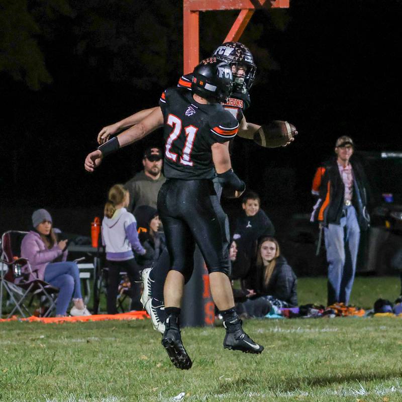 Leelynd Durbin and Elijah Detwiler of Flanagan Cornell Woodland celebrate after Durbin’s touchdown on Friday, October 25, 2024 at Flanagan High School in Flanagan.