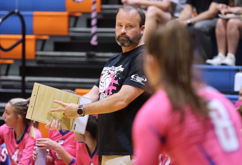 Genoa-Kingston's head coach Keith Foster gives a sign to Alivia Keegan before she serves during their Volley for the Cure match against Oregon Wednesday, Sept. 21, 2022, at Genoa-Kingston High School.