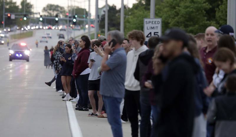 People gather to watch firefighters battle a blaze at Pheasant Run Resort on Saturday in St. Charles.