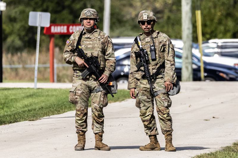 Armed soldiers are stationed at the gates of the Joliet Local Training Area site for the Illinois National Guard at 20612 Arsenal Road in Elwood on Wednesday, Oct. 8, 2025.