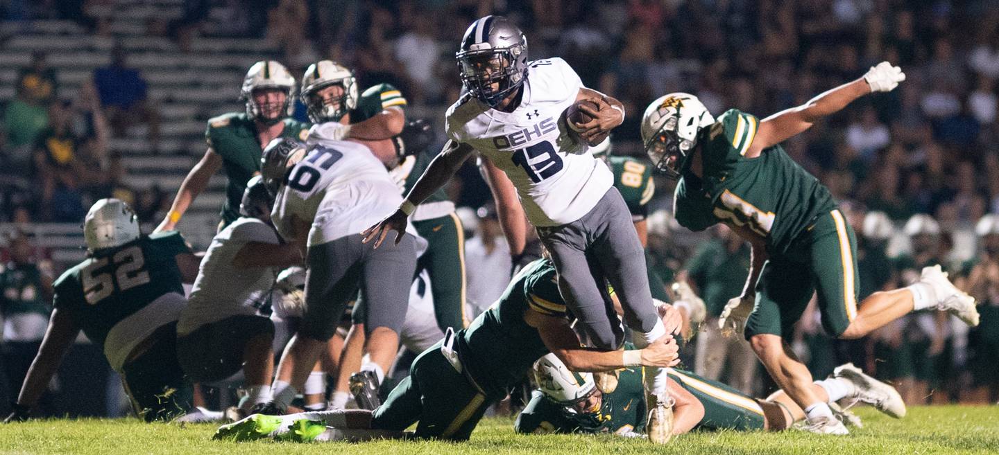 Oswego East's Jasiah Watson (13) carries the ball against Waubonsie Valley during a football game at Waubonsie Valley High School in Aurora on Friday, Aug. 25, 2023.