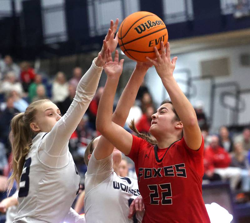Yorkville's Sydney McCabe (right) goes after a rebound against Oswego East's Cassie Van Meter (left) and Aubrey Lamberti during their game Tuesday, Feb. 11, 2025, at Oswego East High School.