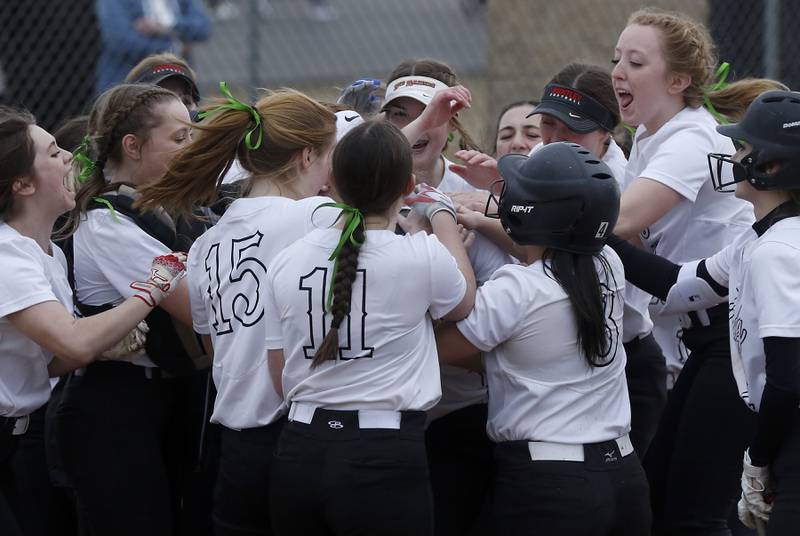 Huntley’s Jori Heard is surrounded by her teammates as she celebrates her home run during a non-conference softball game Thursday March 17, 2022, between Huntley and Fremd at Huntley High School.