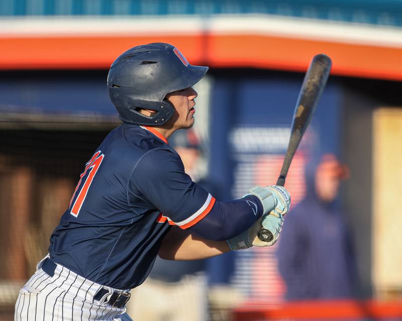 Oswego's Isaiah Logan (11) admires his hit during baseball game between Plainfield South at Oswego on Monday, April 14, 2025 in Oswego.