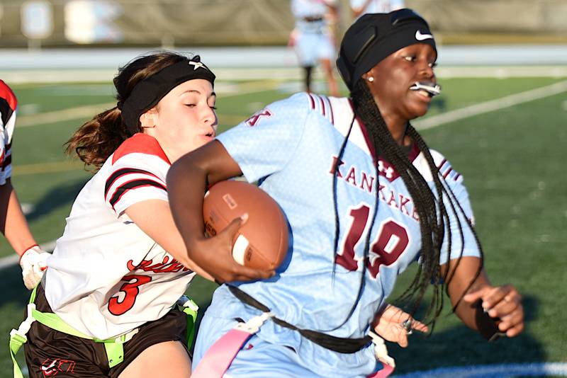 Bradley-Bourbonnais' Sophia Brandenburg, left, looks to pull a flag from Kankakee's London Stroud during the All-City game at Kankakee Wednesday, Sept. 17, 2025.