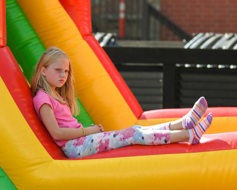 Alaina Landwer, 8, of Sycamore enjoys relaxing on an inflatable bouncy house during the Taste of DeKalb on Sunday, Sept. 29, 2024, downtown.