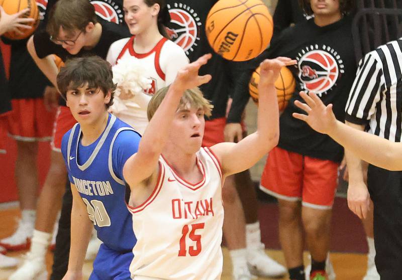 Ottawa's Dane Schmitz passes the ball into the lane as Princeton's Cayden Benavidez watches from behind during the Dean Riley Shootin' The Rock Thanksgiving Tournament on Monday Nov. 24, 2025 in Kingman Gymnasium at Ottawa High School.