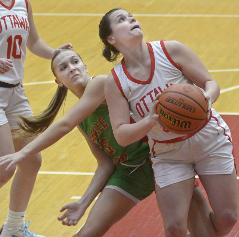 Ottawa’s Kendall Lowery eyes the basket as she gets past the Cavalier’s Kaylee Abens Thursday during the 1st period at Ottawa.