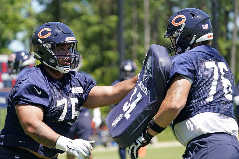 Chicago Bears offensive tackle Larry Borom, left, works with Teven Jenkins during practice, June 16, 2021, at Halas Hall.