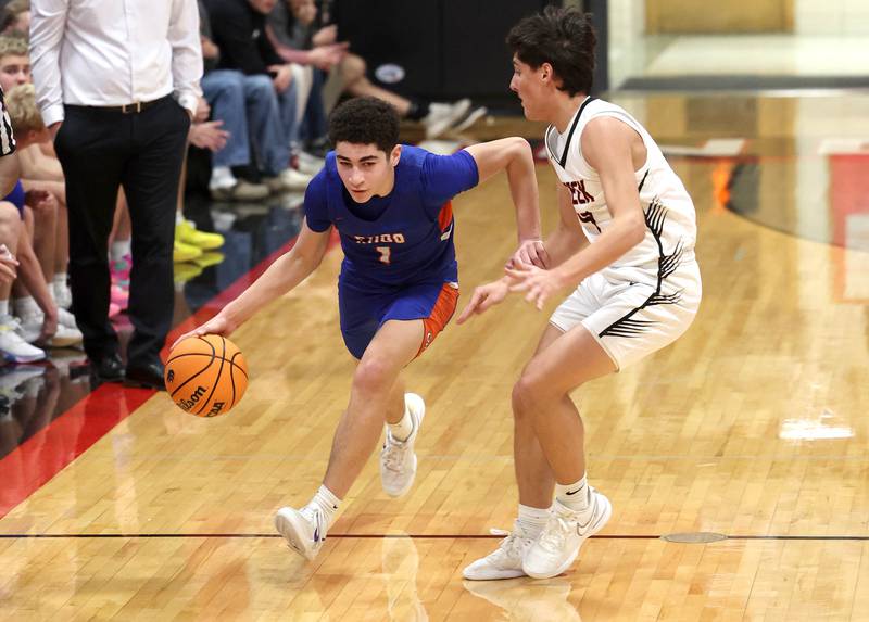 Genoa-Kingston's Marcus Johnson tries to get by the full court pressure of Genoa-Kingston's Cody Cravatta during their game Friday, Jan. 3, 2025, at Indian Creek High School in Shabbona.