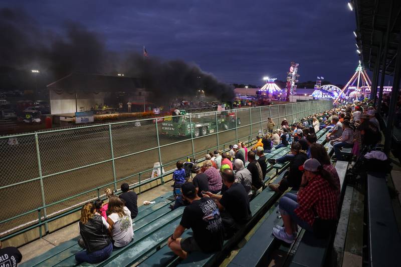 A tractor competes in the Illinois Tractor Pulling Association Truck and Tractor Pull during the Will County Fair on Thursday, Aug. 21, 2025.