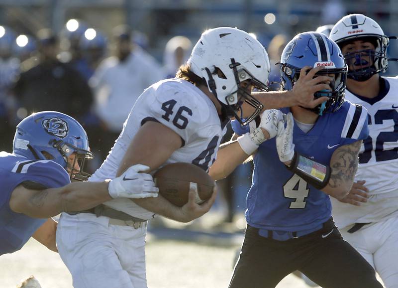 Cary-Grove's Logan Abrams stiff arms Lake Zurich's Nolan Siko as he scores a touchdown during a IHSA Class 6A semifinal playoff football game on Saturday, Nov. 18, 2023, at Lake Zurich High School.