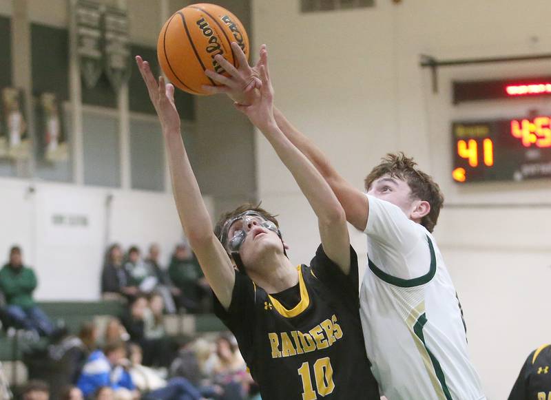 St. Bede's Gino Ferrari knocks the ball away from Ashton-Franklin Center's Nate Becker during the Class 1A Regional quarterfinal game on Monday, Feb. 24, 2025 at St. Bede Academy.