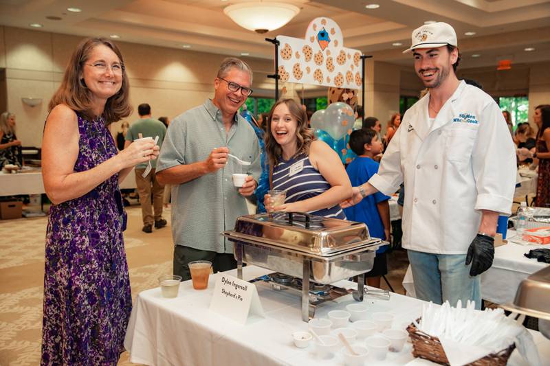 Conni Villella, Joe Villella and Grace Ingersoll stand with Dylan Ingersoll during the 2023 50 Men Who Cook fundraiser.