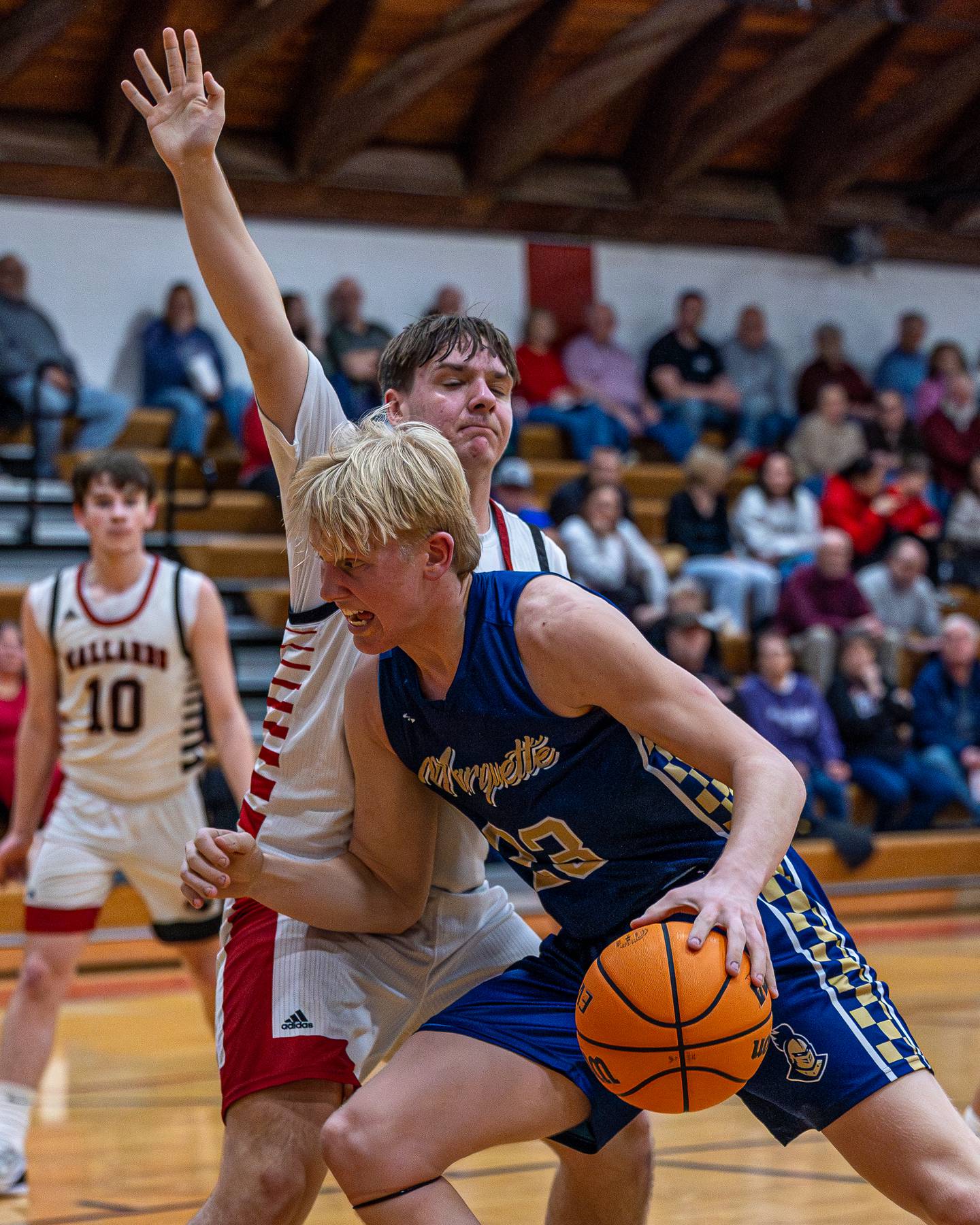 Marquette's Luke McCullough works in the paint against Henry-Senachwime's Bobby Gaspardo during Friday's Tri-County Conference game in Henry.