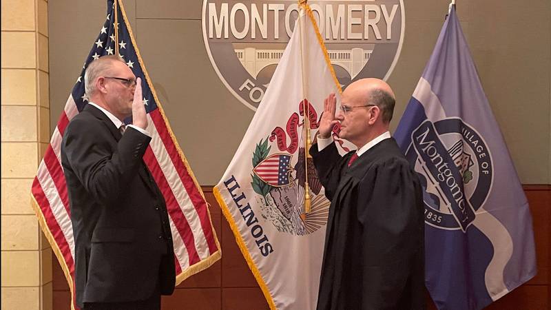 Kendall County Judge Stephen Krentz, right, swore Ben Brzoska, left, into duty at the Feb. 12 Village Board Board meeting.