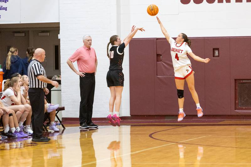 St. Charles East's Kathlyn Bainbridge shoots a three pointer over Benet's Ava Mersinger at the Montini Christmas Tournament on Tuesday, Dec.23,2025 in Lombard.