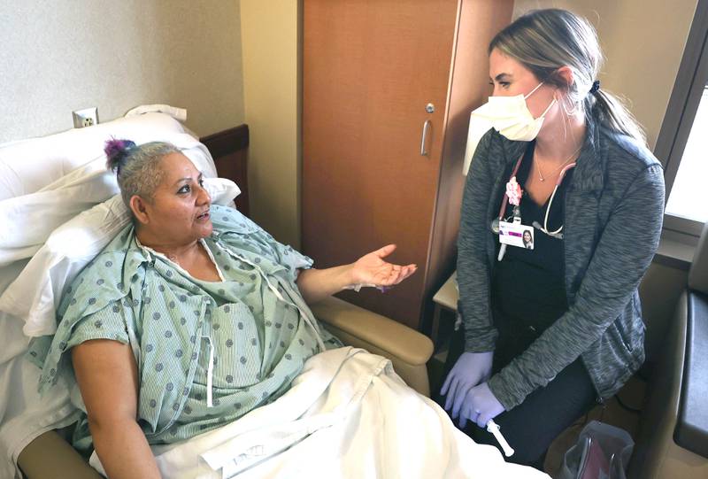 Travel nurse Alexandra Pop talks to patient Maria Gallardo, of DeKalb, Wednesday, March 23, 2022, at Northwestern Medicine Kishwaukee Hospital in DeKalb.
