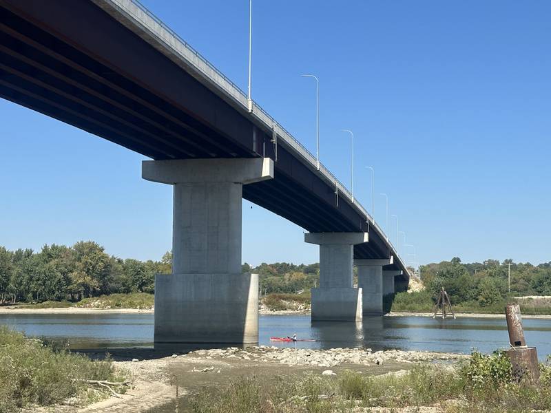 A kayaker passes underneath the Illinois Route 89 bridge on Tuesday, Sept. 16, 2025 in Spring Valley. The shoreline creeps towards the first peer as water records flirt with record-low numbers.