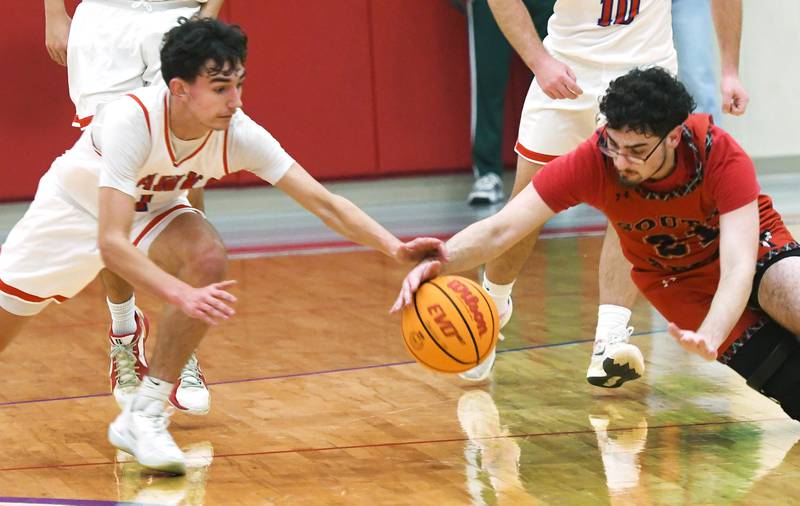 Oregon's Benny Olalde (1) and South Beloit's Payton Winterland (21) dive for a loose ball on Monday, Nov. 24, 2025 during the Oregon Boys Basketball Thanksgiving Tournament in Oregon.