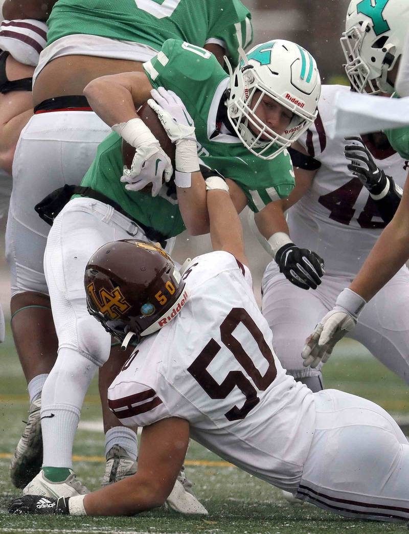 Loyola's Justin Trott (50) reaches up and gets a hand on York’s Brian Grant (10) during the IHSA Class 8A semifinal football game Saturday November 19, 2022 in Elmhurst.