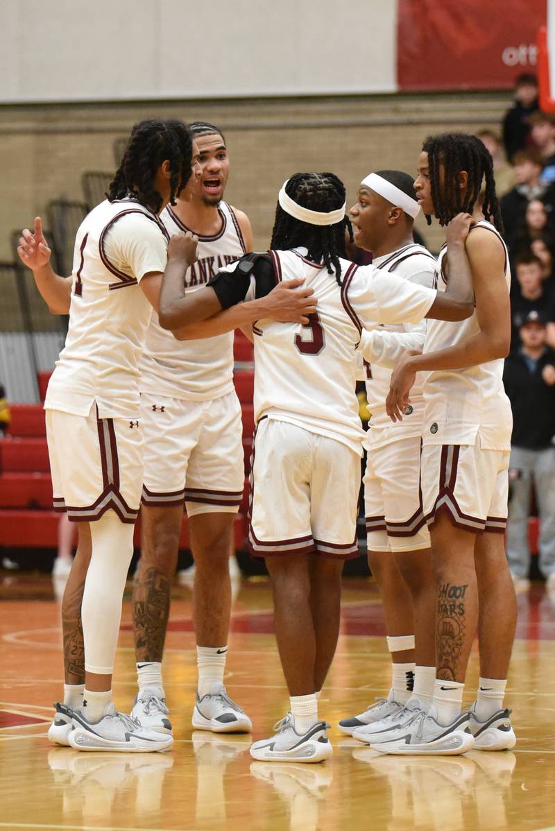 Members of the Kankakee boys basketball team huddle up during a break in the Kays' IHSA Class 3A Ottawa Sectional semifinal agaisnt East Peoria Wednesday, March 4, 2026.