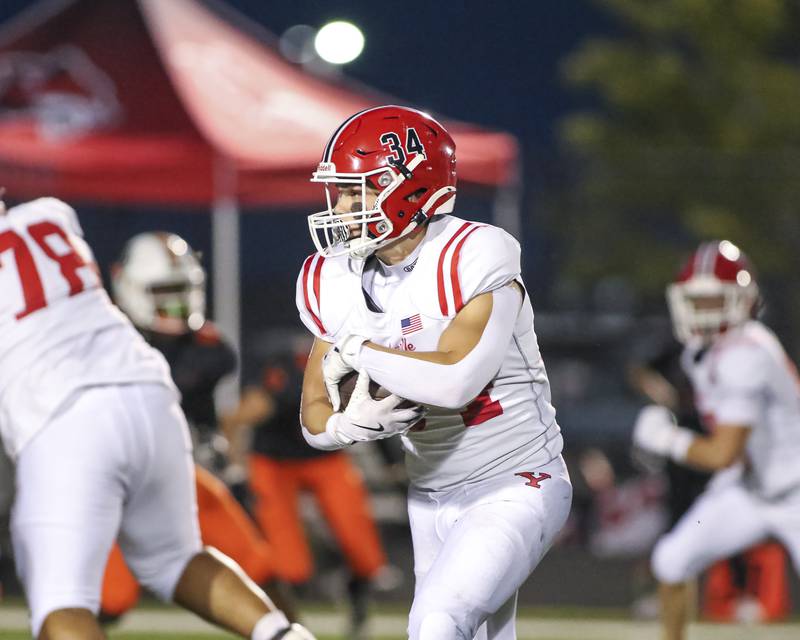 Yorkville's Gavin Geegan (34) takes off with the ball on the way to the endzone during football game between Yorkville at Plainfield East Friday, Sept 19, 2025 in Plainfield.