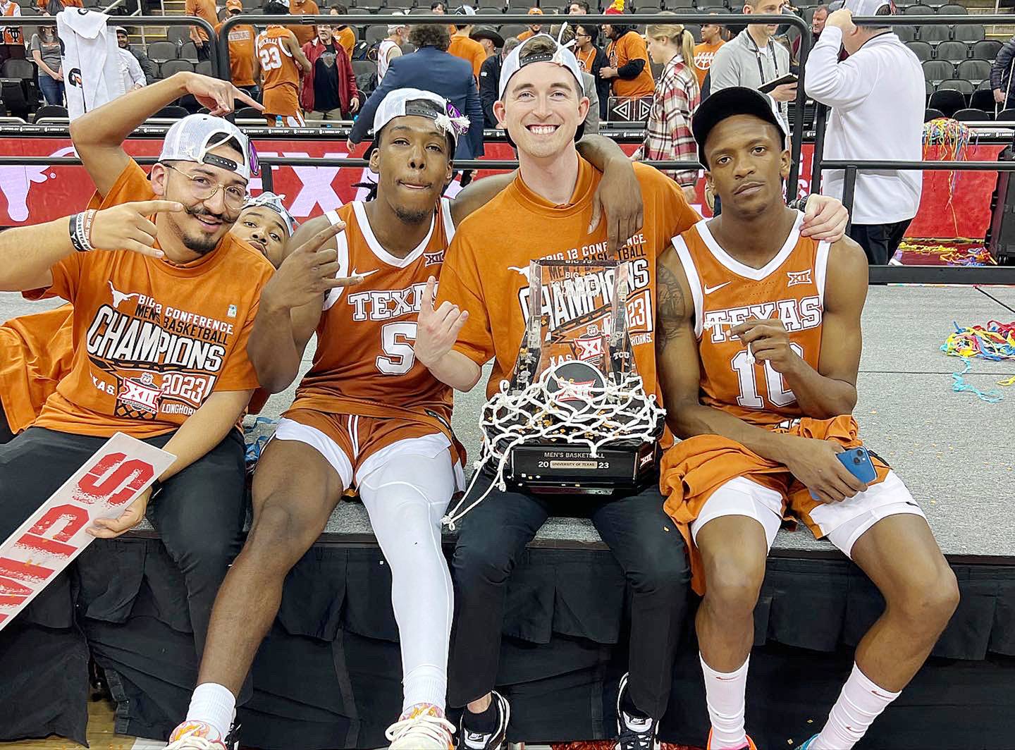 Rock Falls native KJ Conklin (second from right) poses with Texas basketball players Marcus Carr (5) and Sir'Jabari Rice after the Longhorns won the Big 12 Tournament championship last season.