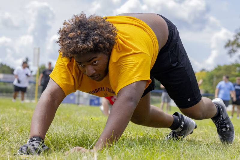 Michael Thornhill of Mendota High School participates in the weight plate push relay during a multiple high school practice football meet at Princeton High School on July 20, 2024.
