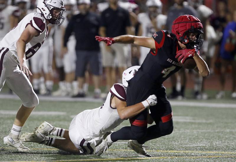 Huntley's Connor Wade is tackled by Prairie Ridge's Elijah Loeding during a Fox Valley Conference football game on Friday, Oct. 3, 2025, at Huntley High School.