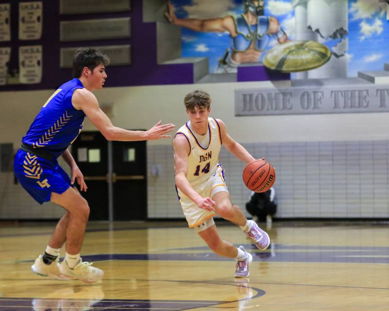 Downers Grove North's Max Haack (14) drives towards the lane during varsity basketball game between Lyons at Downers Grove North.  Jan 31, 2023.