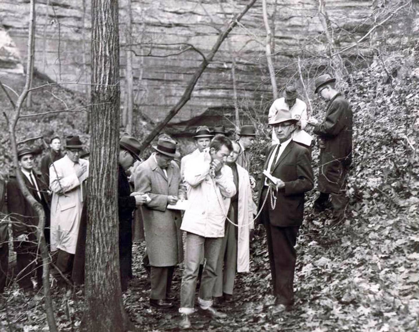 Surrounded by reporters from across the Midwest on Nov. 17, 1960, Chester Weger held in chains by Sheriff Ray Eutsey reenacts the crime in which he confessed to killing three women from Riverside inside St. Louis Canyon at Starved Rock State Park on Marh14 of that year. Weger now claims he was physically abused into making those admissions and has again petition the state for parole.